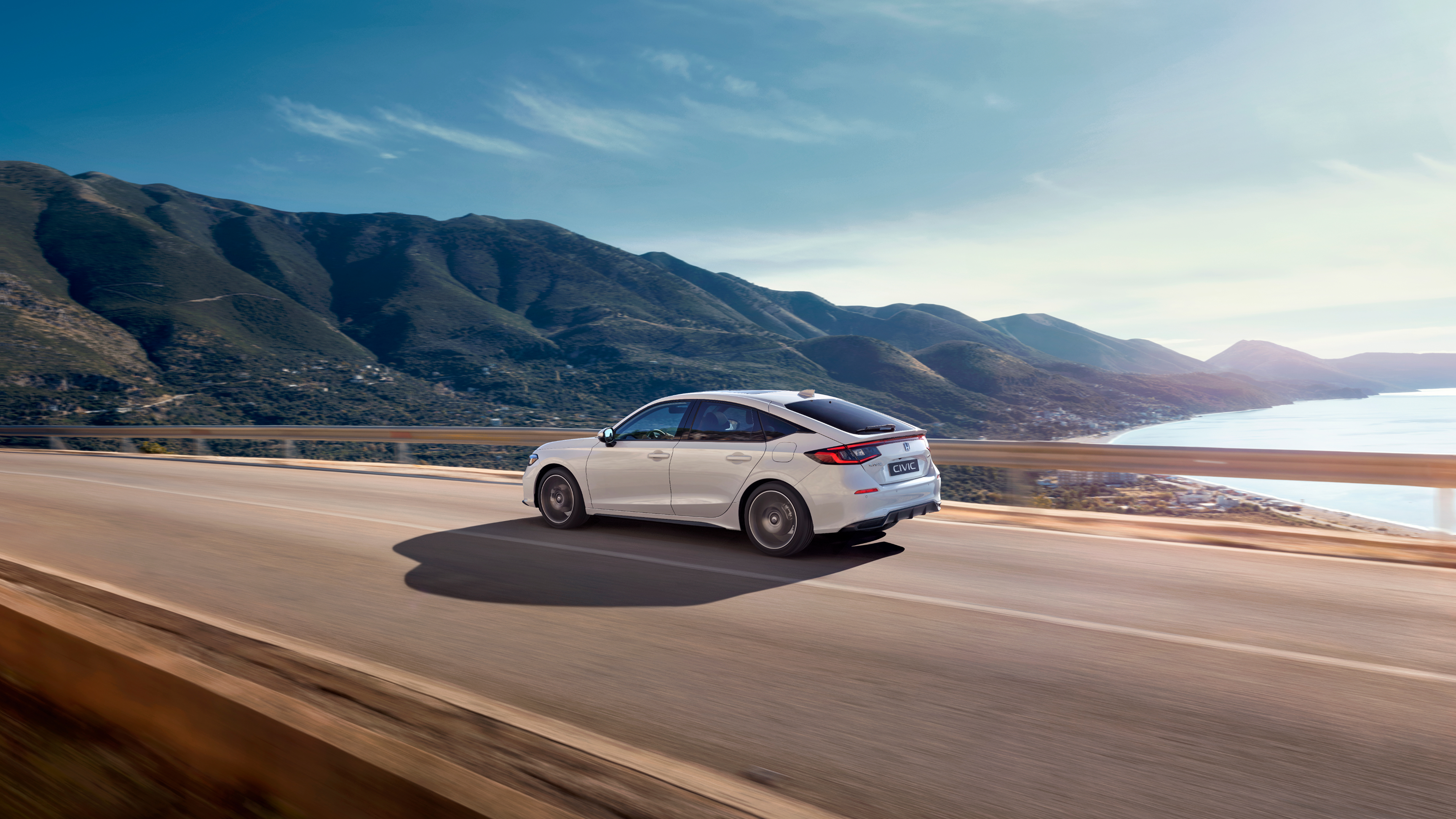 Honda Civic Hybrid driving on a highway, on a scenic route.